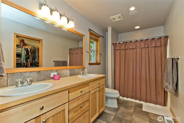 25012 67th Ave E, Graham, WA 98338 - bathroom featuring visible vents, a sink, double vanity, and toilet