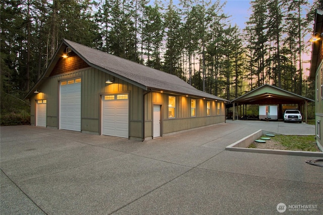 25012 67th Ave E, Graham, WA 98338 - garage at dusk with a carport and a detached garage