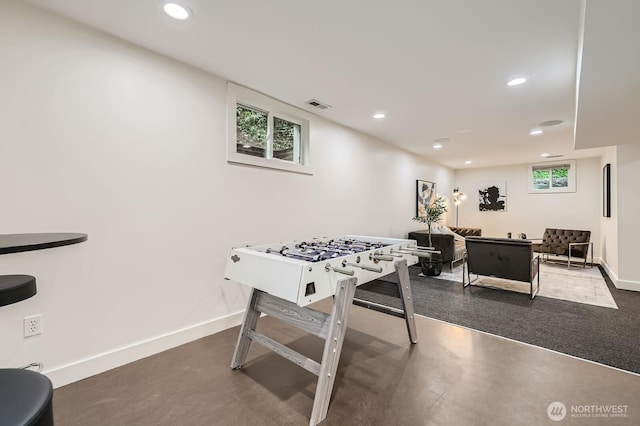 recreation room featuring recessed lighting, finished concrete flooring, and visible vents