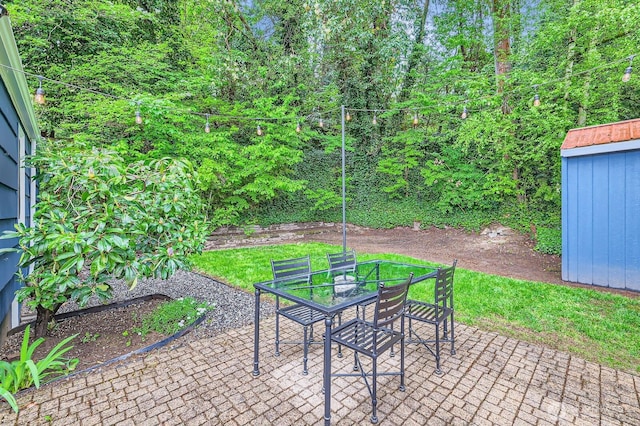 view of patio with an outbuilding and outdoor dining area