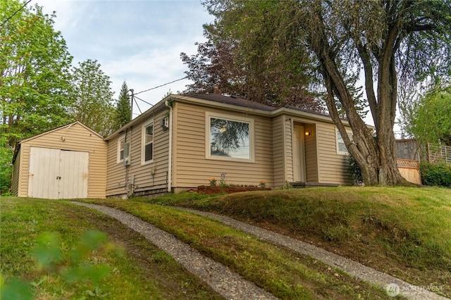 914 Puget St NE, Olympia, WA 98506 - bungalow featuring a detached garage, an outdoor structure, and a storage unit