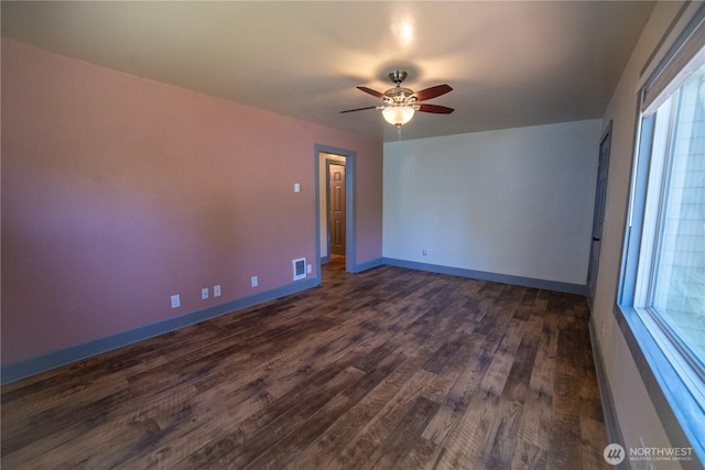 914 Puget St NE, Olympia, WA 98506 - spare room featuring baseboards, a ceiling fan, dark wood finished floors, and visible vents