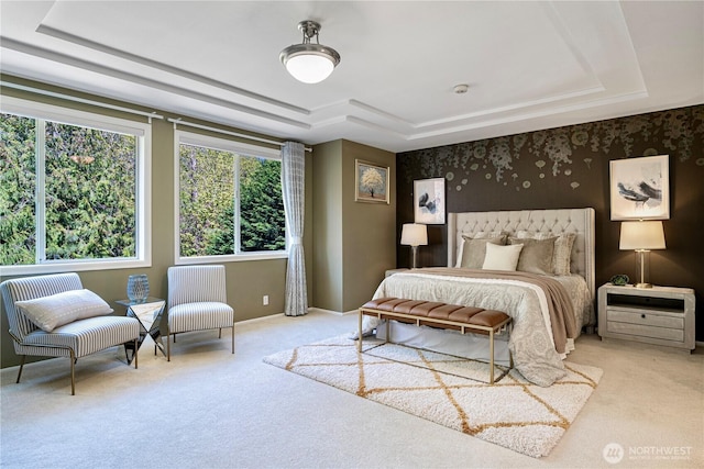 carpeted bedroom with a raised ceiling and wallpapered walls