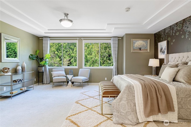 carpeted bedroom featuring a tray ceiling and baseboards