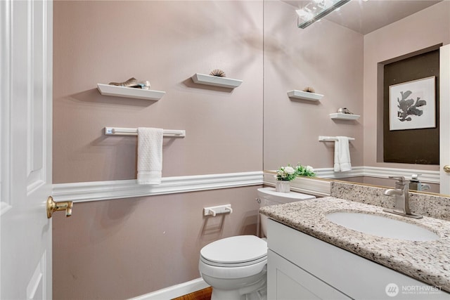 bathroom with toilet and vanity