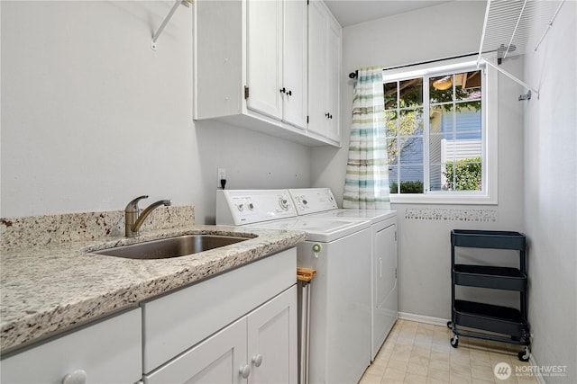 laundry area with washer and dryer, baseboards, a sink, cabinet space, and light tile patterned floors
