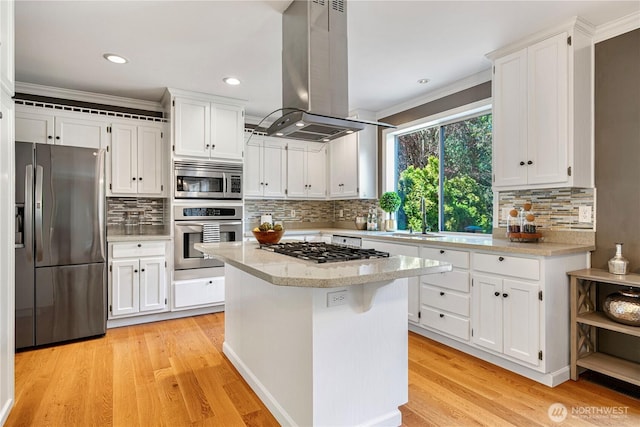 kitchen with a sink, white cabinetry, island range hood, and stainless steel appliances