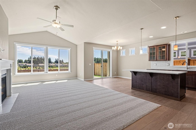 9621 7th Ave SE, Lacey, WA 98513 - kitchen featuring light wood-style floors, light countertops, open floor plan, a center island, and a breakfast bar