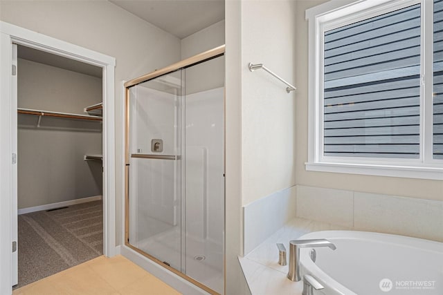9621 7th Ave SE, Lacey, WA 98513 - bathroom featuring a stall shower, a spacious closet, and a garden tub