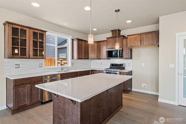 9621 7th Ave SE, Lacey, WA 98513 - kitchen featuring stainless steel appliances, light wood finished floors, backsplash, light countertops, and recessed lighting