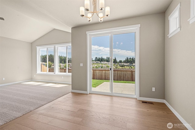 9621 7th Ave SE, Lacey, WA 98513 - unfurnished room featuring wood-type flooring, a chandelier, and lofted ceiling
