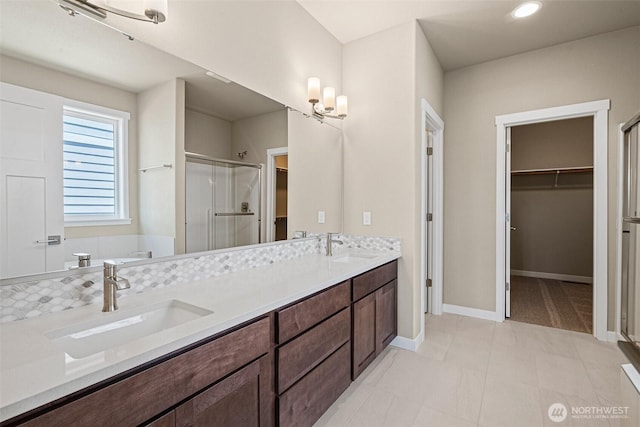 9621 7th Ave SE, Lacey, WA 98513 - bathroom with a spacious closet, a shower stall, double vanity, a bathtub, and recessed lighting