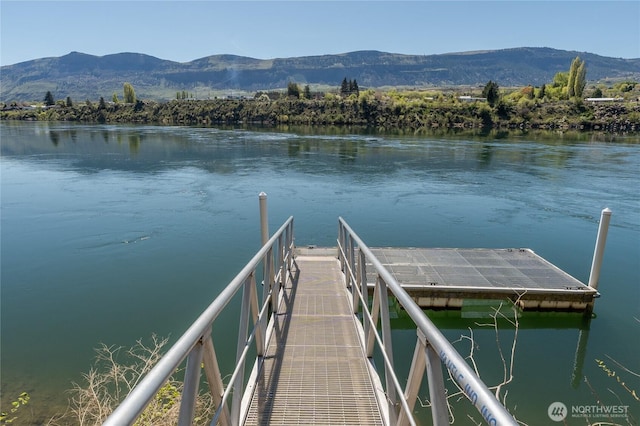 dock area with a water and mountain view