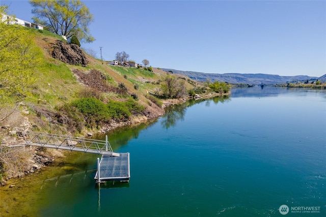 property view of water featuring a floating dock and a mountain view