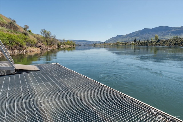dock area with a water and mountain view