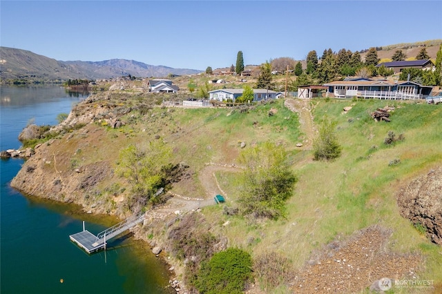 drone / aerial view with a water and mountain view