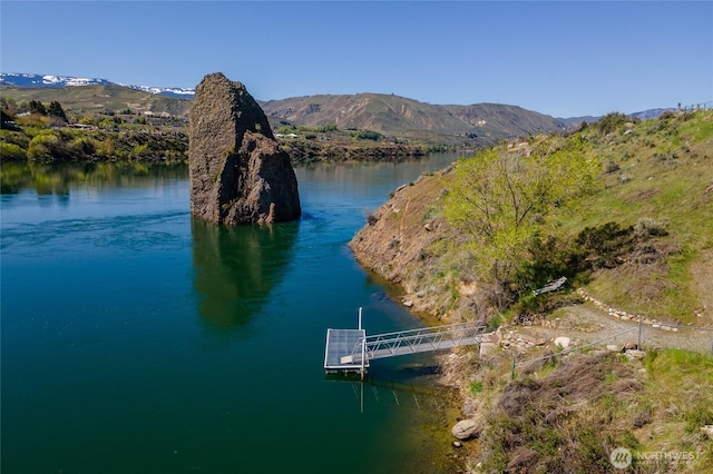 exterior space with a water and mountain view