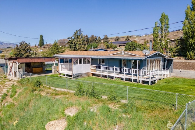 back of house with a lawn and a fenced backyard