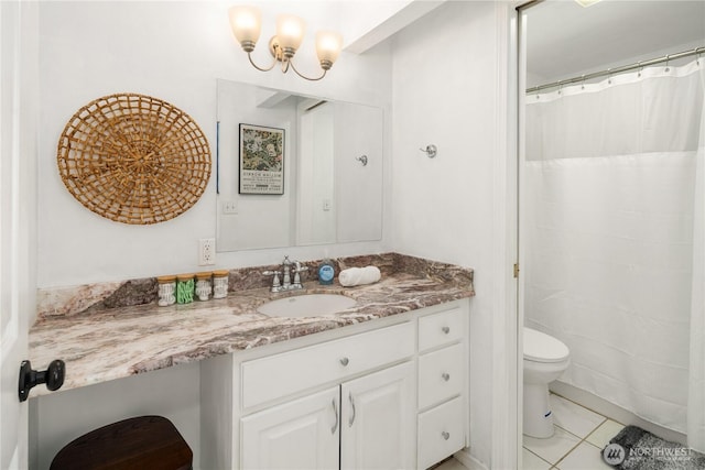 bathroom featuring vanity, tile patterned flooring, and toilet