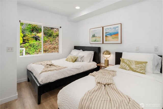 bedroom with recessed lighting, baseboards, and wood finished floors