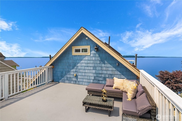 view of patio / terrace featuring a water view, an outdoor hangout area, and a balcony