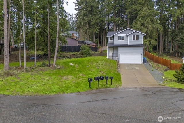 view of front facade with a front yard, an attached garage, concrete driveway, and fence