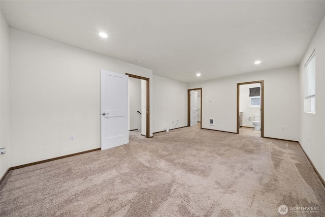 below grade area with light carpet, visible vents, and recessed lighting