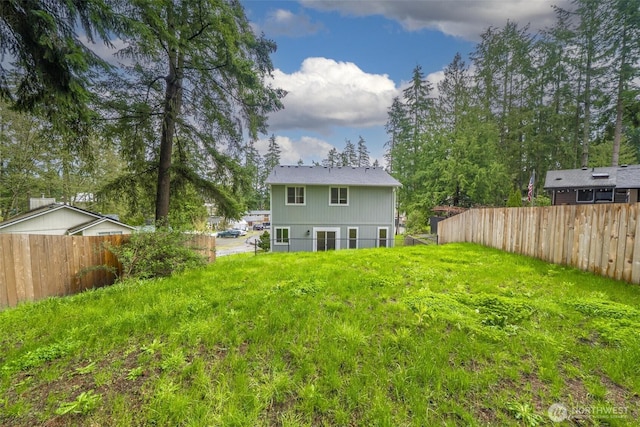 rear view of property featuring fence