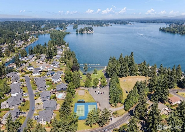 birds eye view of property with a water view and a residential view