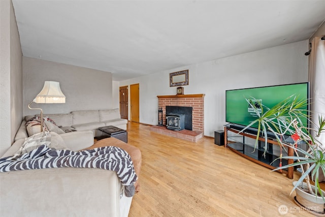 living area featuring wood finished floors and a wood stove