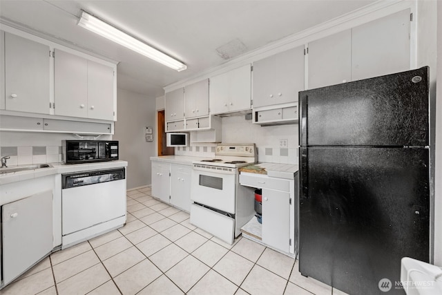 kitchen with white cabinets, tile countertops, light tile patterned floors, a sink, and black appliances