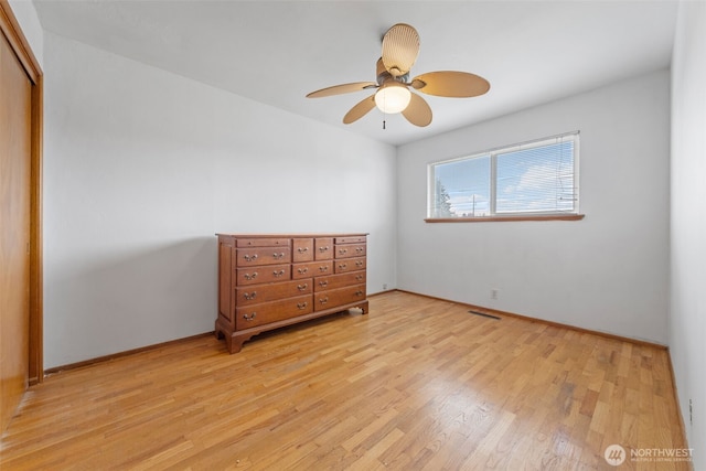 bedroom with a ceiling fan, a closet, light wood-style flooring, baseboards, and visible vents