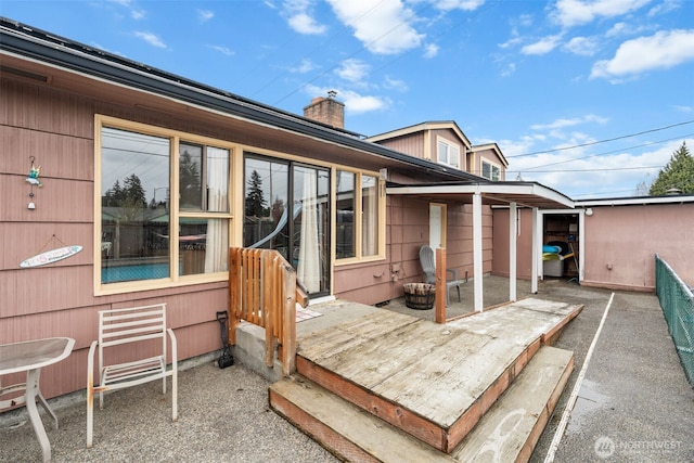 exterior space featuring a patio area and a chimney
