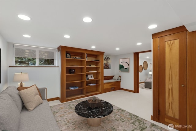 living area featuring baseboards and recessed lighting