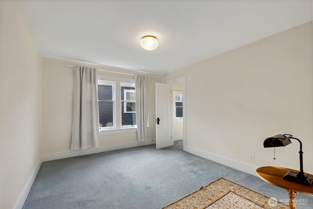 empty room with carpet floors and baseboards