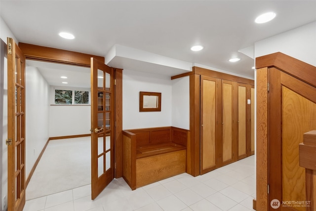 hallway with french doors, recessed lighting, and wainscoting
