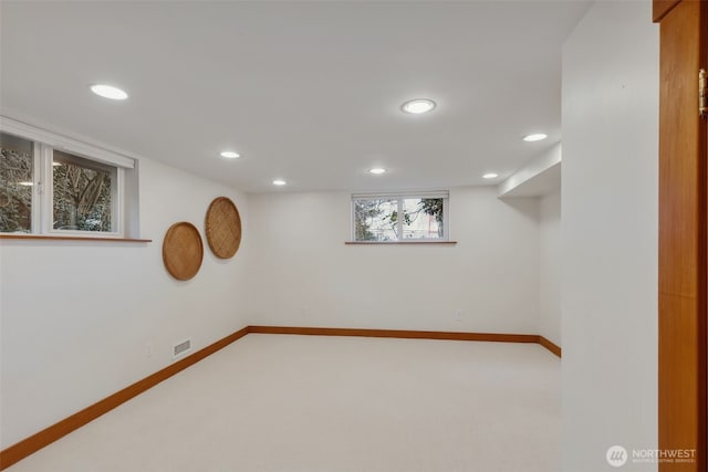 below grade area with recessed lighting, carpet, baseboards, and visible vents