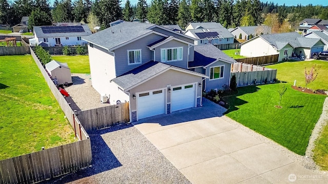 806 Cody St SE, Rainier, WA 98576 - traditional home featuring driveway, a residential view, a shingled roof, and stone siding