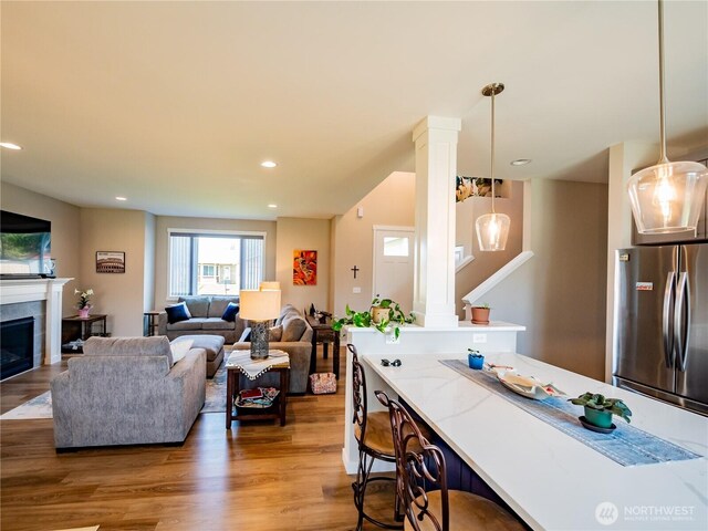 806 Cody St SE, Rainier, WA 98576 - living room featuring ornate columns, wood finished floors, recessed lighting, and a fireplace
