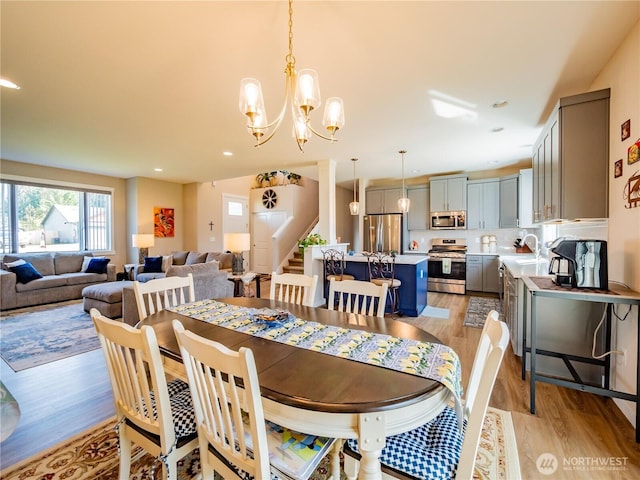 806 Cody St SE, Rainier, WA 98576 - dining area with light wood-style floors, a chandelier, stairway, and recessed lighting