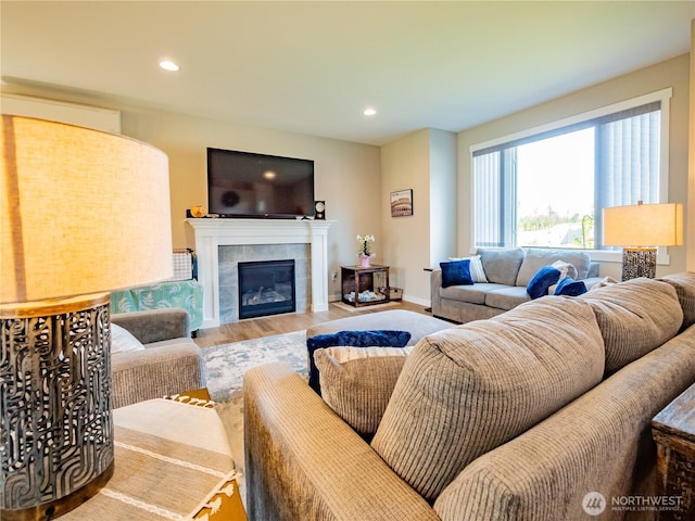 806 Cody St SE, Rainier, WA 98576 - living area featuring wood finished floors, a tiled fireplace, recessed lighting, and baseboards