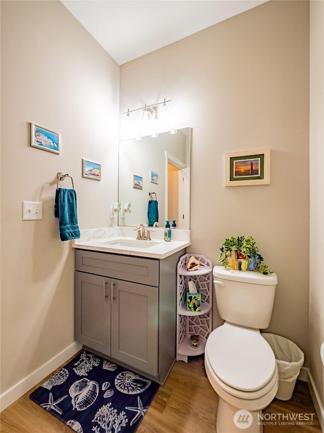 806 Cody St SE, Rainier, WA 98576 - bathroom with toilet, wood finished floors, vanity, and baseboards