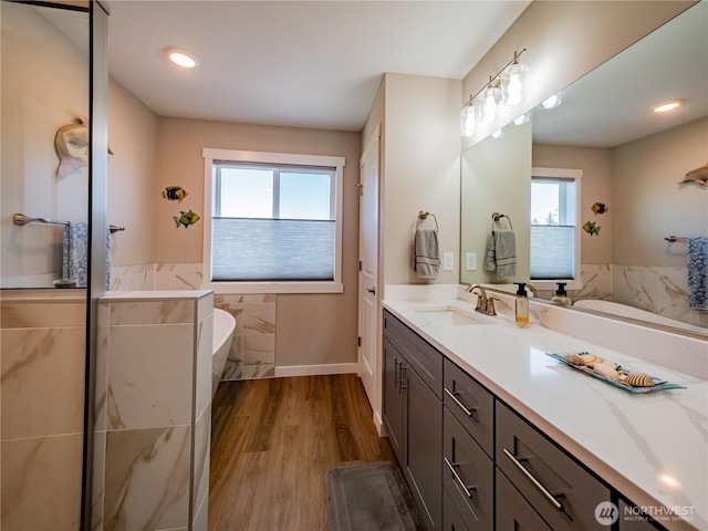 806 Cody St SE, Rainier, WA 98576 - full bathroom featuring healthy amount of natural light, vanity, a freestanding bath, and wood finished floors