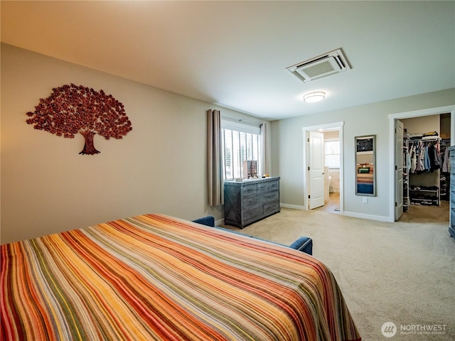 806 Cody St SE, Rainier, WA 98576 - bedroom with light carpet, a spacious closet, ensuite bath, baseboards, and attic access