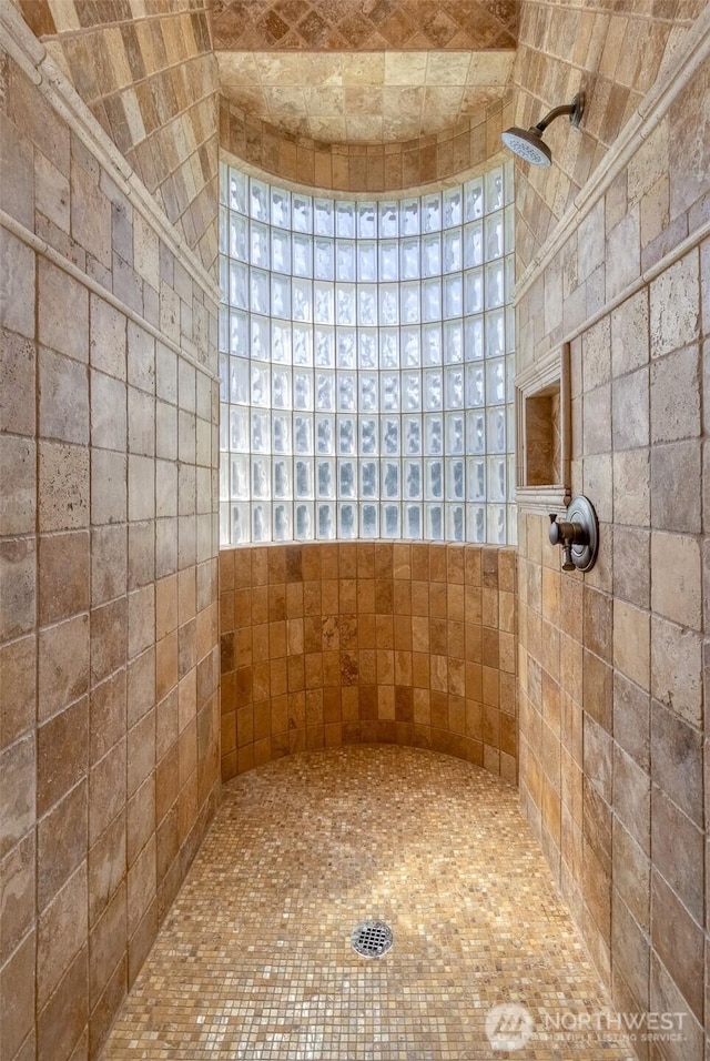 bathroom with tiled shower