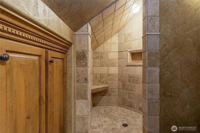 bathroom with a tile shower