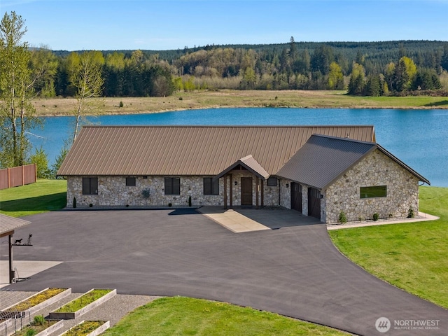6401 Skookumchuck Rd SE, Tenino, WA 98589 - view of front facade with stone siding, a wooded view, and a water view