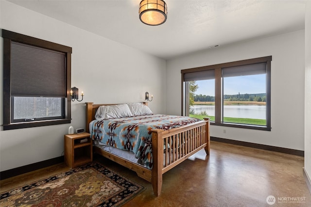 6401 Skookumchuck Rd SE, Tenino, WA 98589 - bedroom with finished concrete flooring, baseboards, visible vents, and a water view