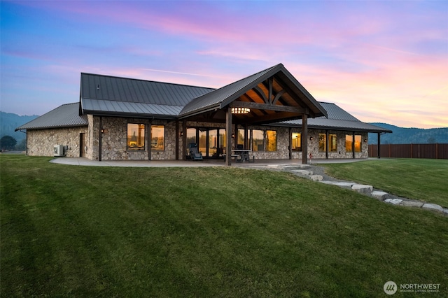 6401 Skookumchuck Rd SE, Tenino, WA 98589 - rear view of house featuring stone siding, a patio area, a yard, and metal roof