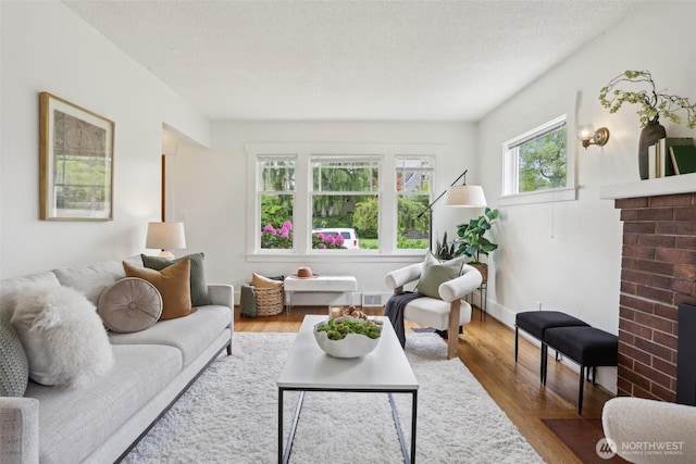 living area featuring a fireplace and wood finished floors